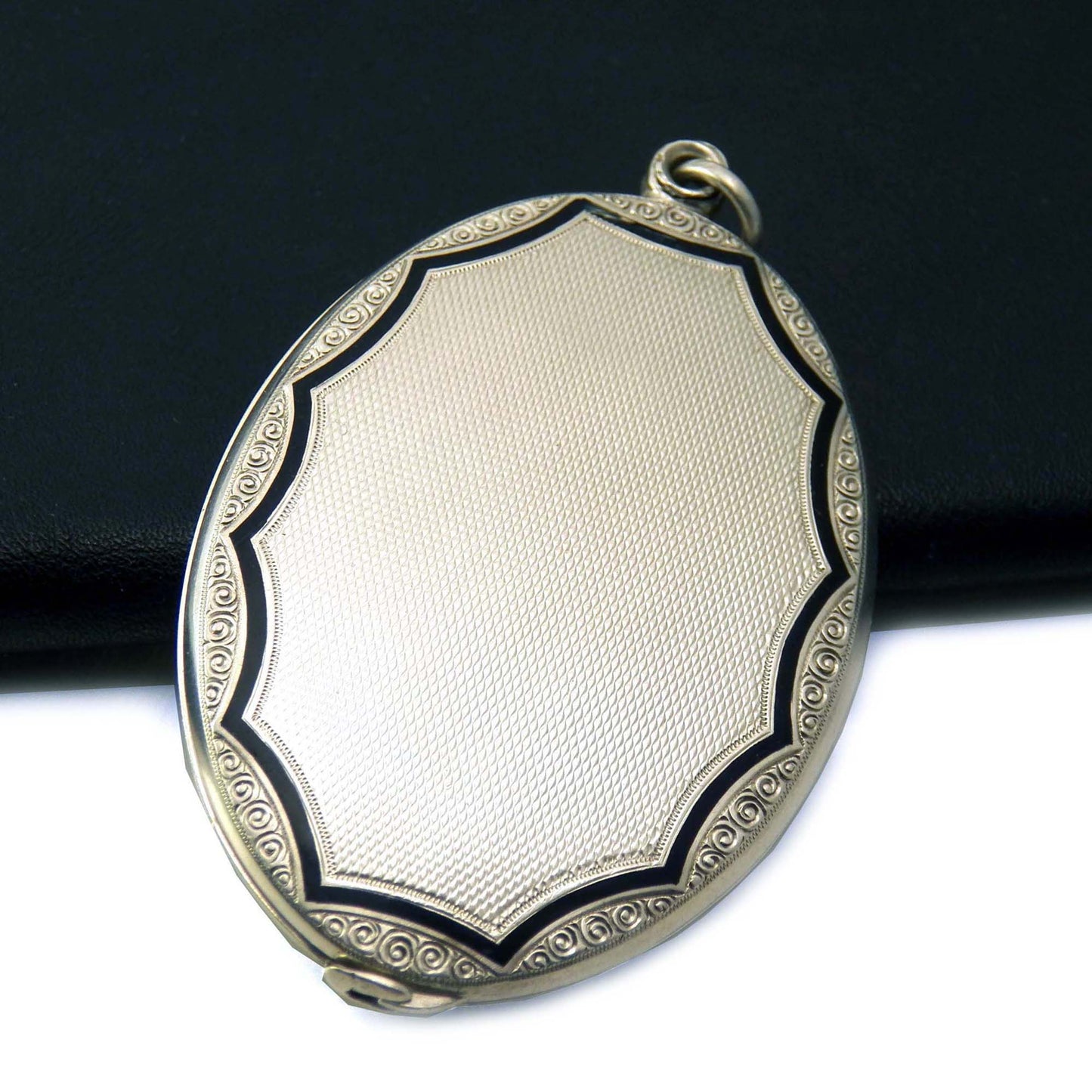 Antique slide locket in sterling silver with black enamel edging