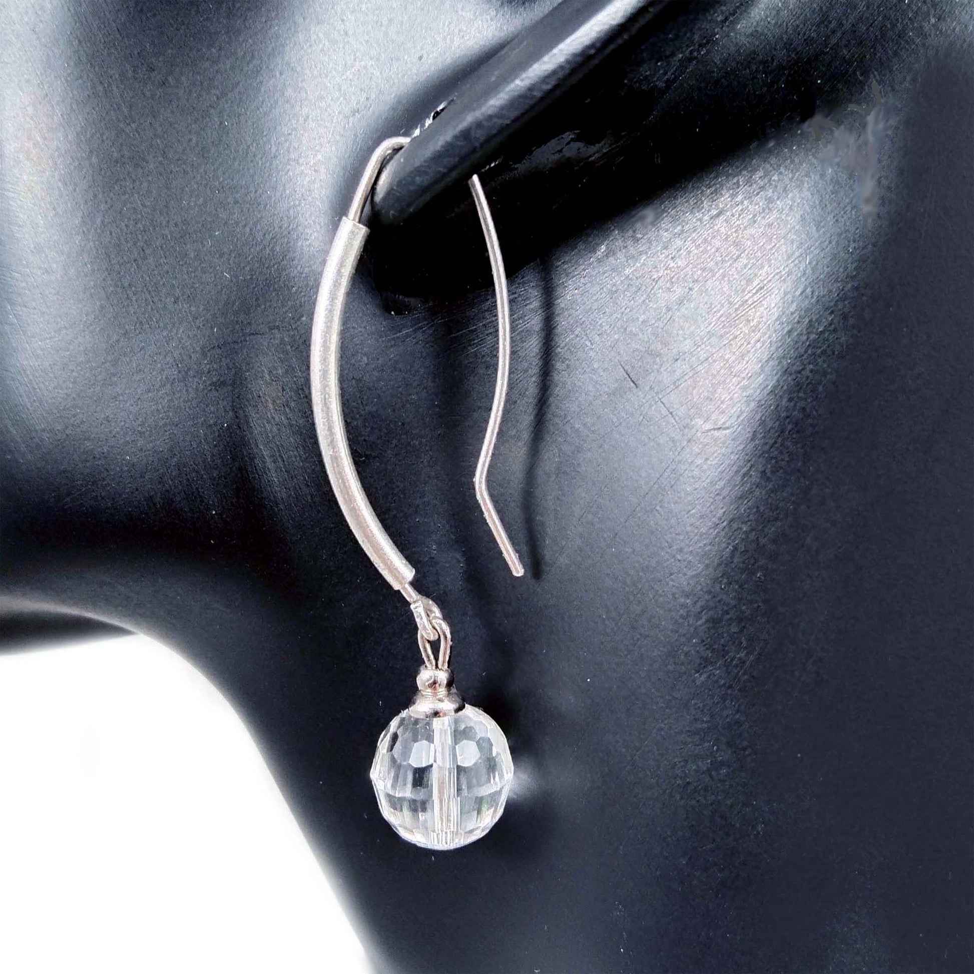 Faceted clear quartz ball earrings with long silver ear hooks