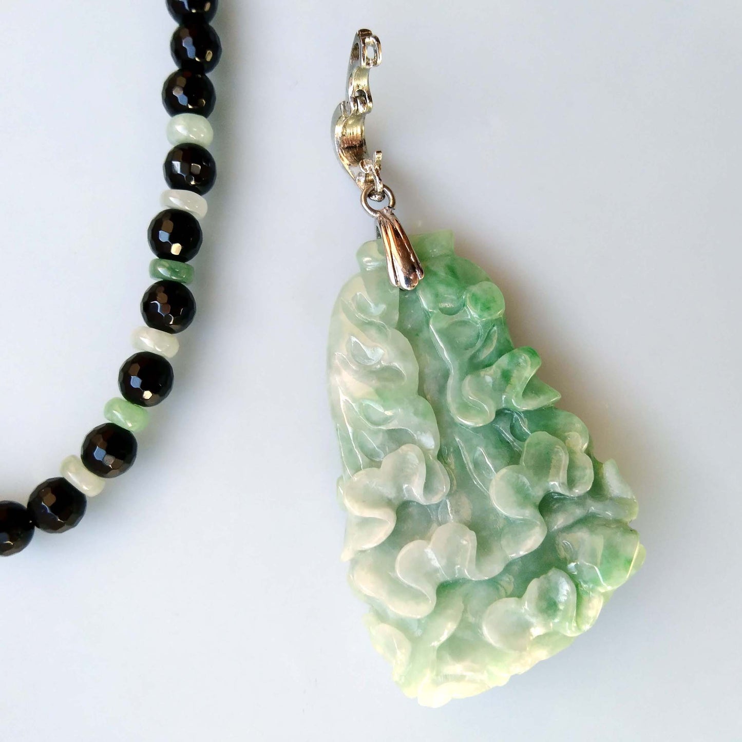 green jade pendant with an intricate pattern